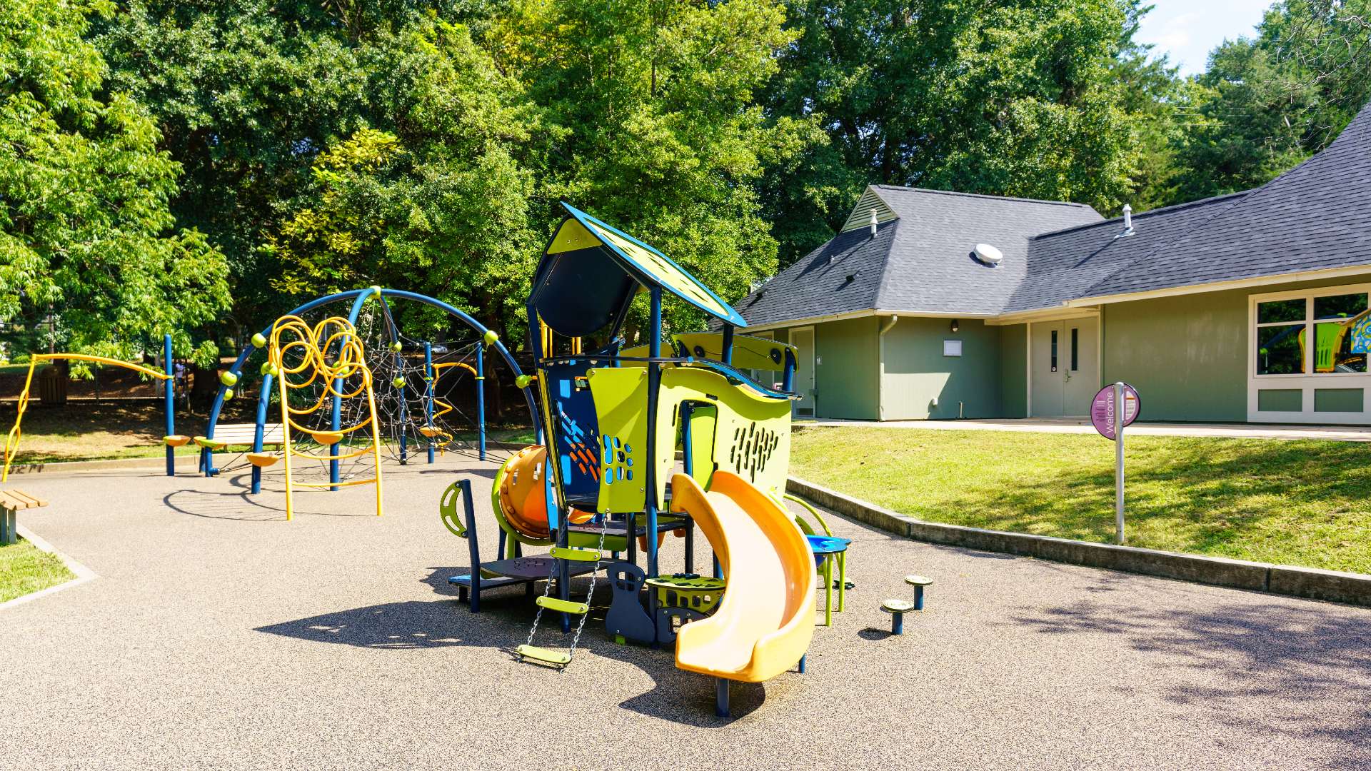 Powell Drive Park with community center in background and playground in foreground