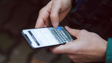 hands texting on a smartphone