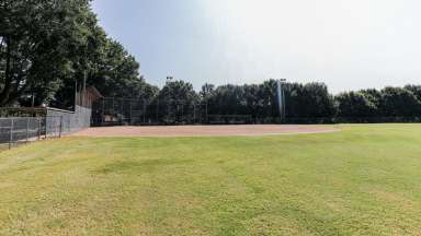 A open softball field with backstop 