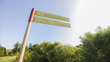 The signage that shows two different greenway trails that can be accessed at the park