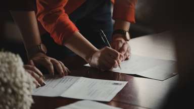 hands of woman filling out paperwork