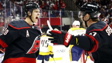 Carolina Hurricanes hockey players celebrating win by feeding each other bananas