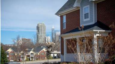 Exterior of affordable housing property with downtown Raleigh in the background