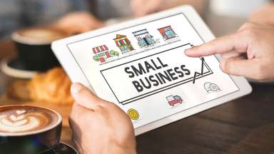 tablet with "small business" and business-related icons on the screen