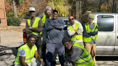 Workforce members pose in safety gear