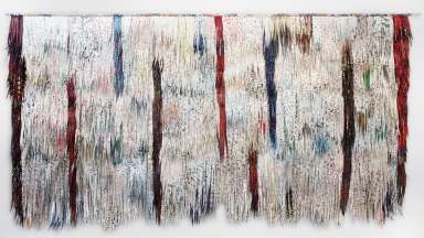 Two dimensional fiber sculpture with feather like fabric making a large white,  rectangular wall hanging with blue, red and purple line markings.