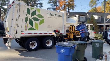 City of Raleigh Recycling truck picking up a recycling bin