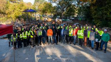 Raleigh Parks staff and RPD officers standing together at Caraleigh park