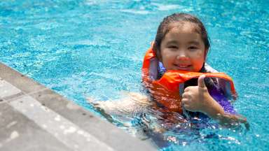 a child playing in a pool