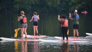 people on paddleboards in a lake