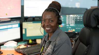 A 9-1-1 operator smiling