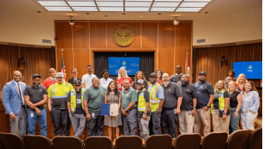 Solid Waste Services staff pose in the council chambers following the proclamation of Waste and Recycling Workers Week.