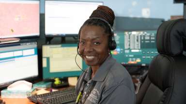 Employee smiling at desk