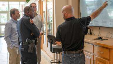 Water leaders and Chief of Police review screen at wastewater plant