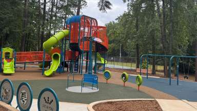 a large colorful playground with children playing