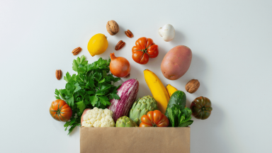 A paper bag full vegetables