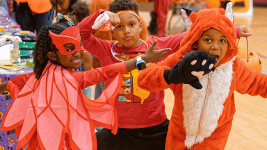 Kinds dress up in Halloween costumes 