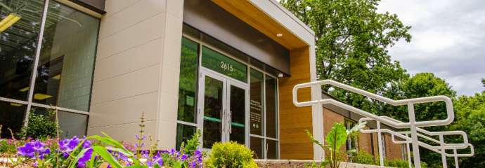 Front doors of Biltmore Hills Community Center with purple flowers