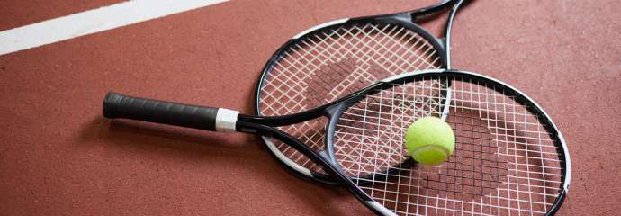 Two tennis racquets with a tennis ball