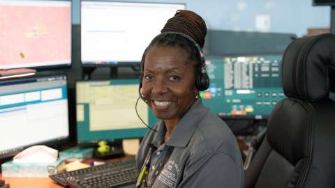 Employee smiling at desk