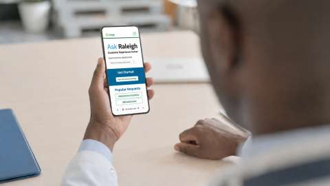 Aske Raleigh - Man holding a phone up with Ask Raleigh webpage on the screen