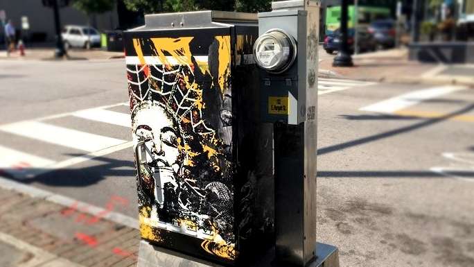 A signal box wrapped in artwork by Cathy Foreman in downtown Raleigh