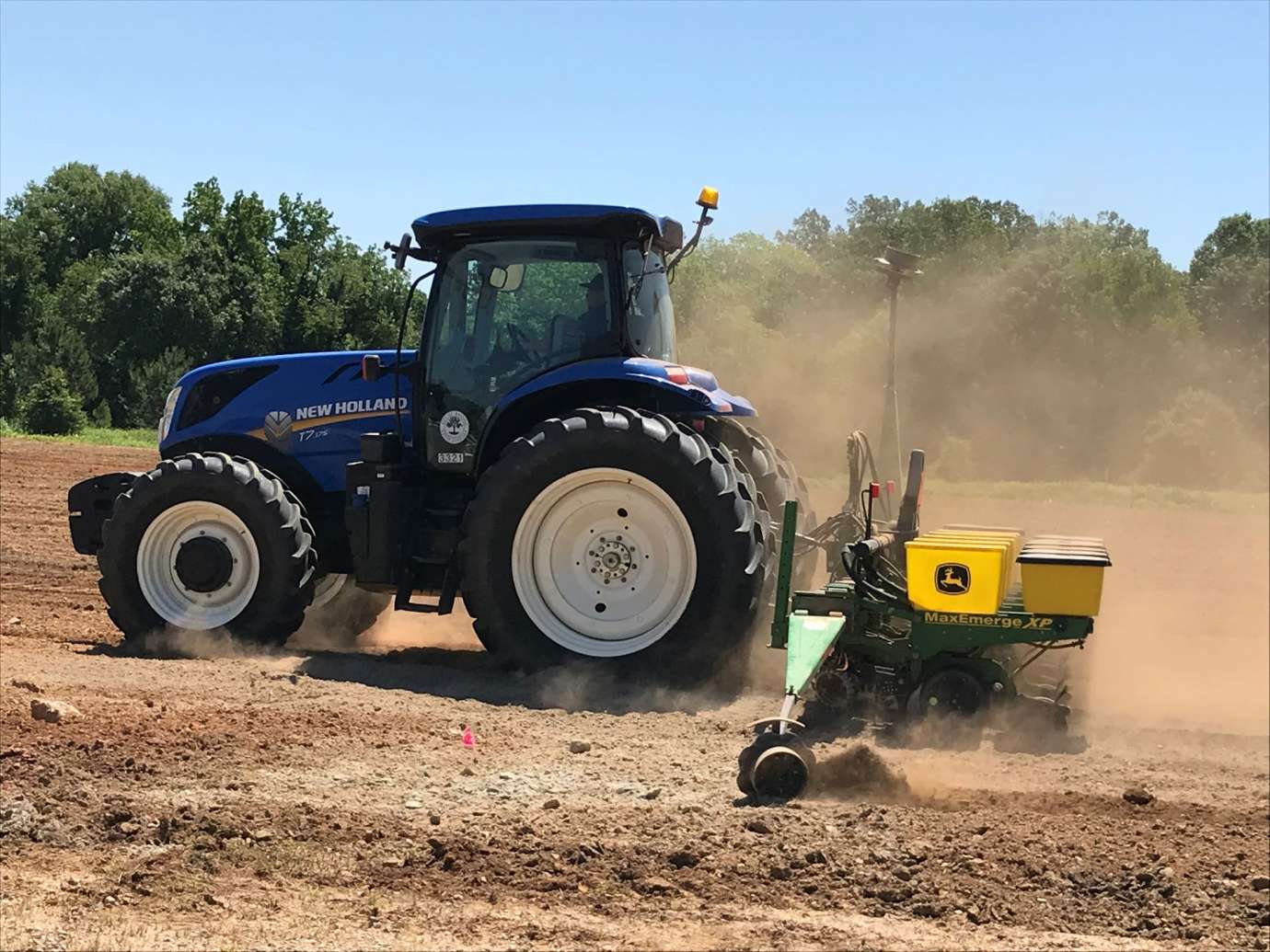 Tractor spreading sunflower seeds at Dix Park