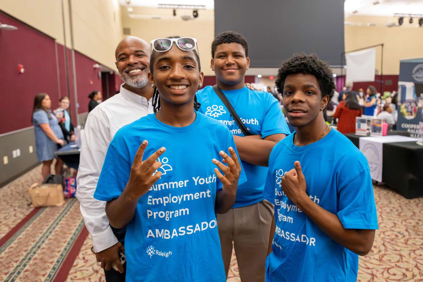 Teenage boys pose for a picture in the exhibit hall
