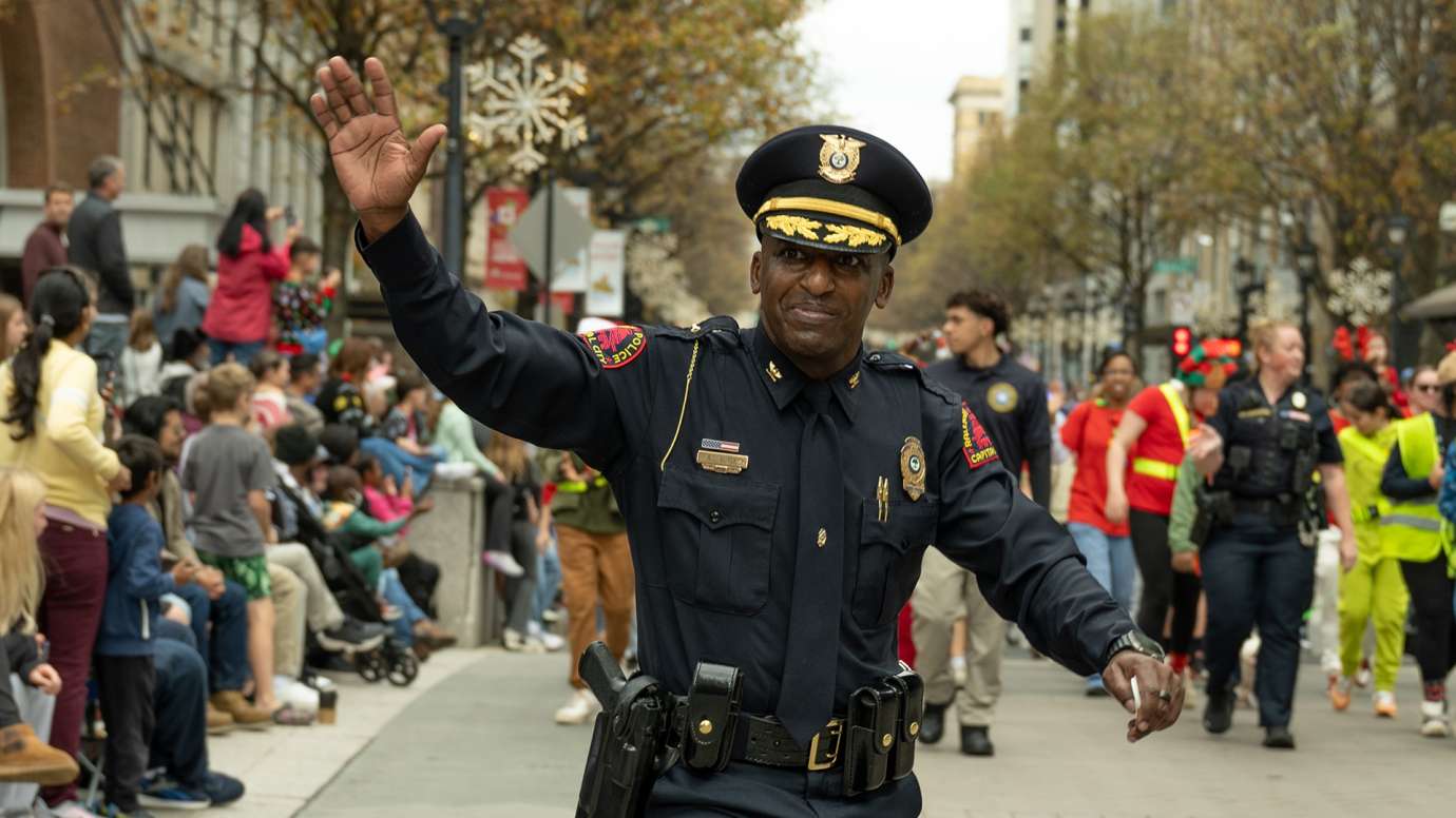 Chief Boyce walking in parade waving