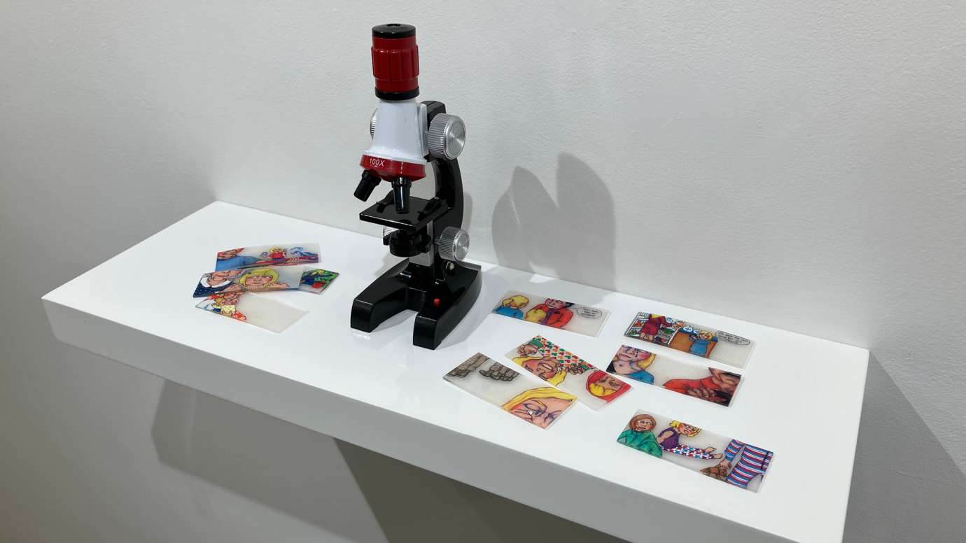 Artwork comprised of small colorful slides to be viewed with the provided  microscope