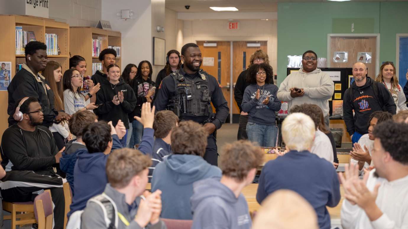 Students in library clapping