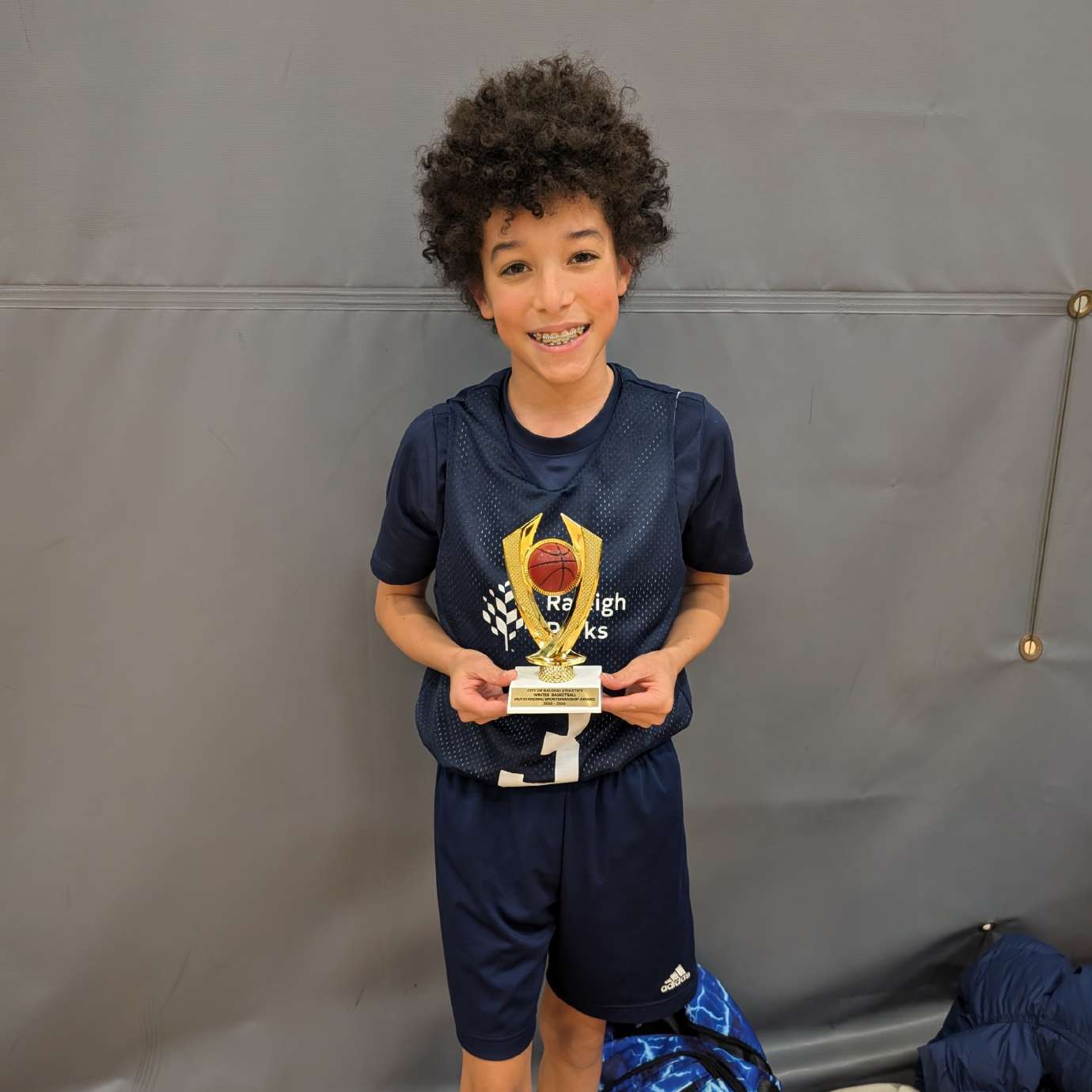 Joah with his basketball trophy