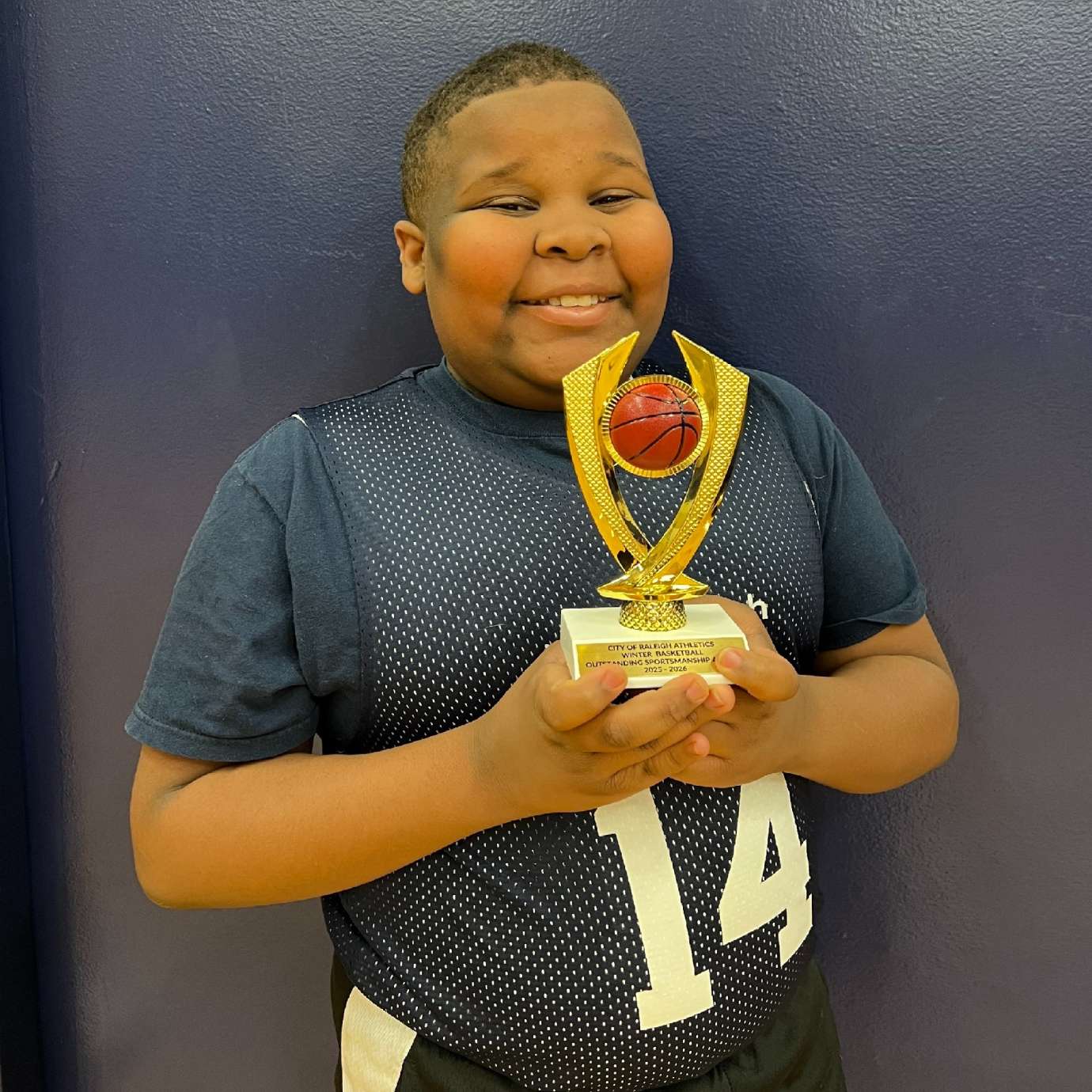 Jaden with his basketball trophy