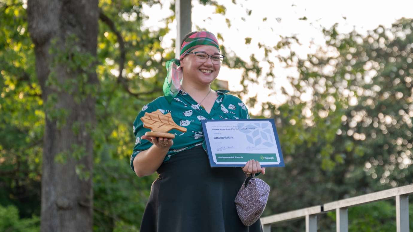 Person holding certificate and award