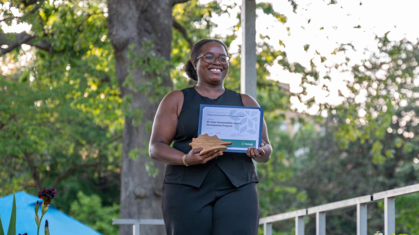 Woman smiling and holding award