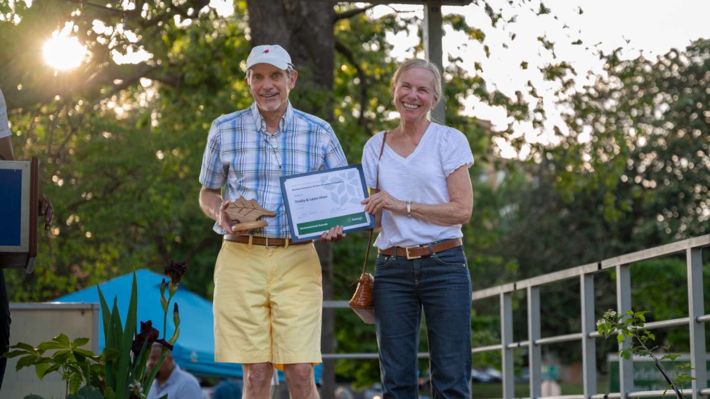 Man and woman holding award