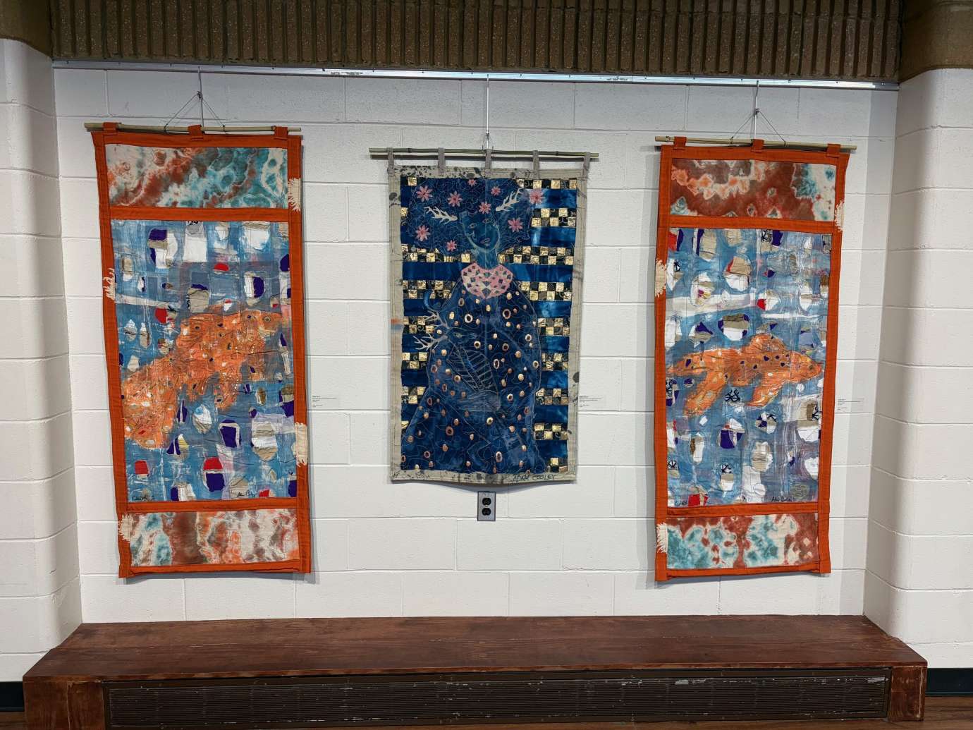 Works by Adam Cooley hanging on a wall 