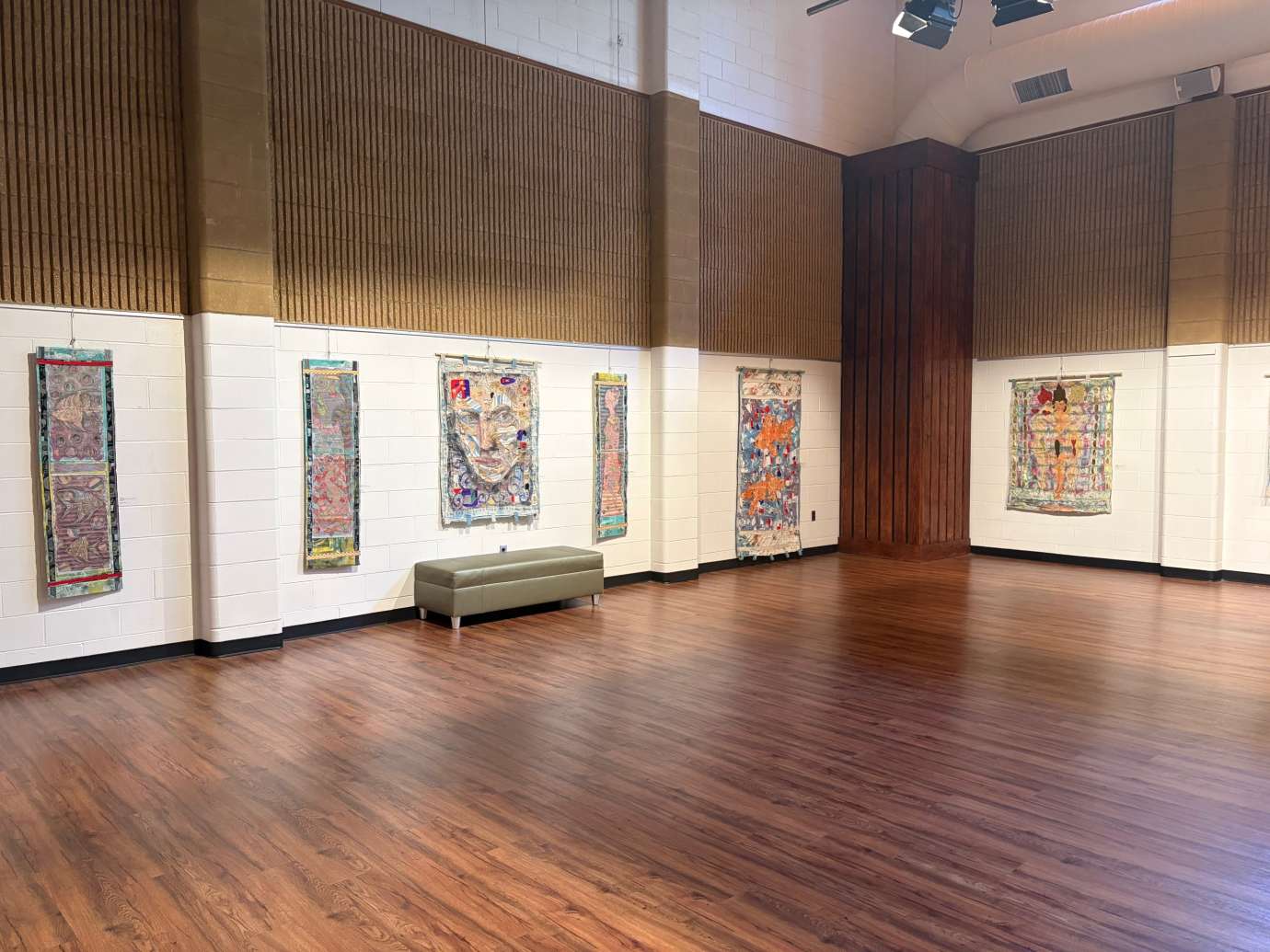 Works by Adam Cooley hanging in a large room 