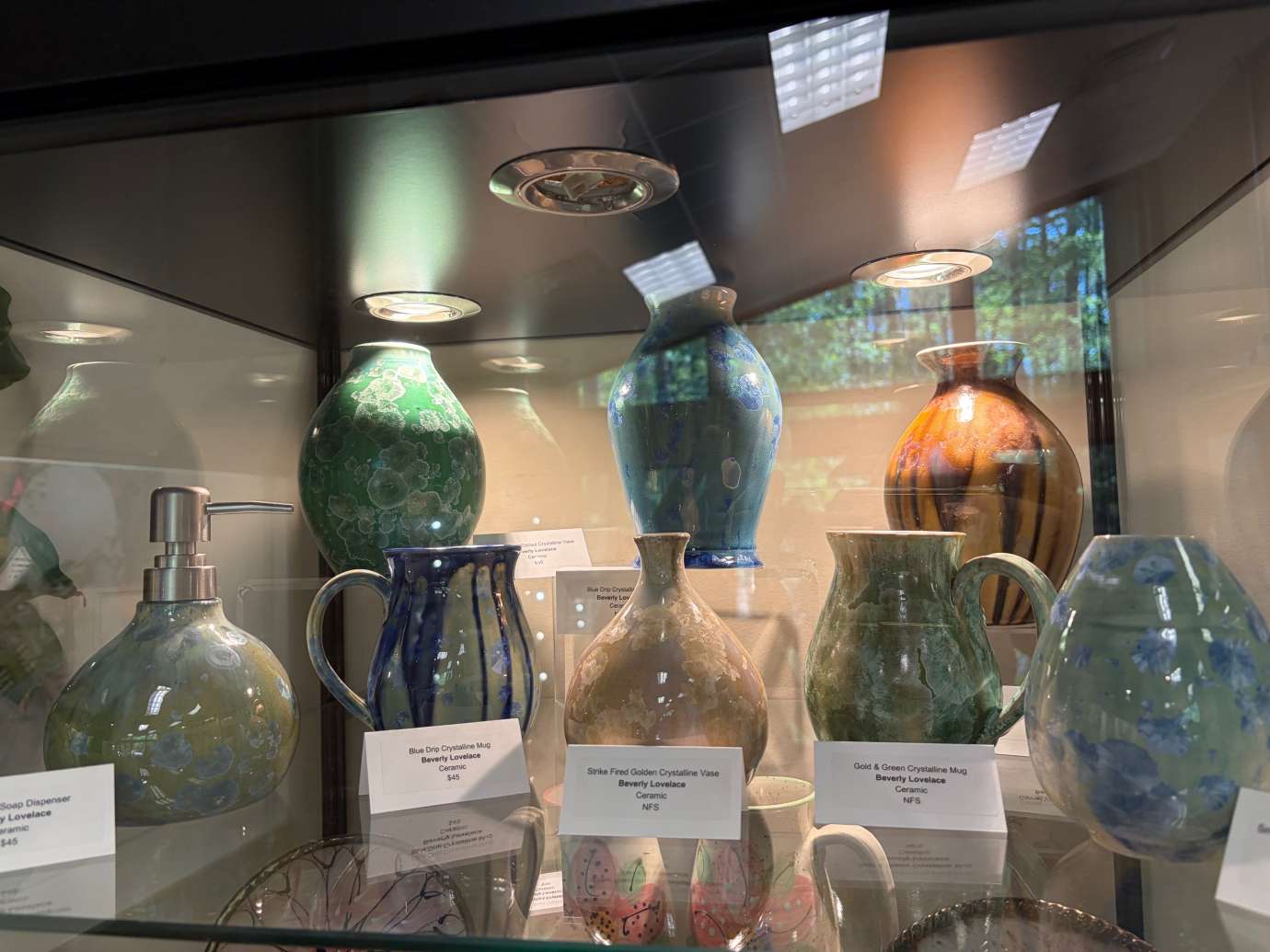 Pottery by Beverly Lovelace in a Glass Display case 