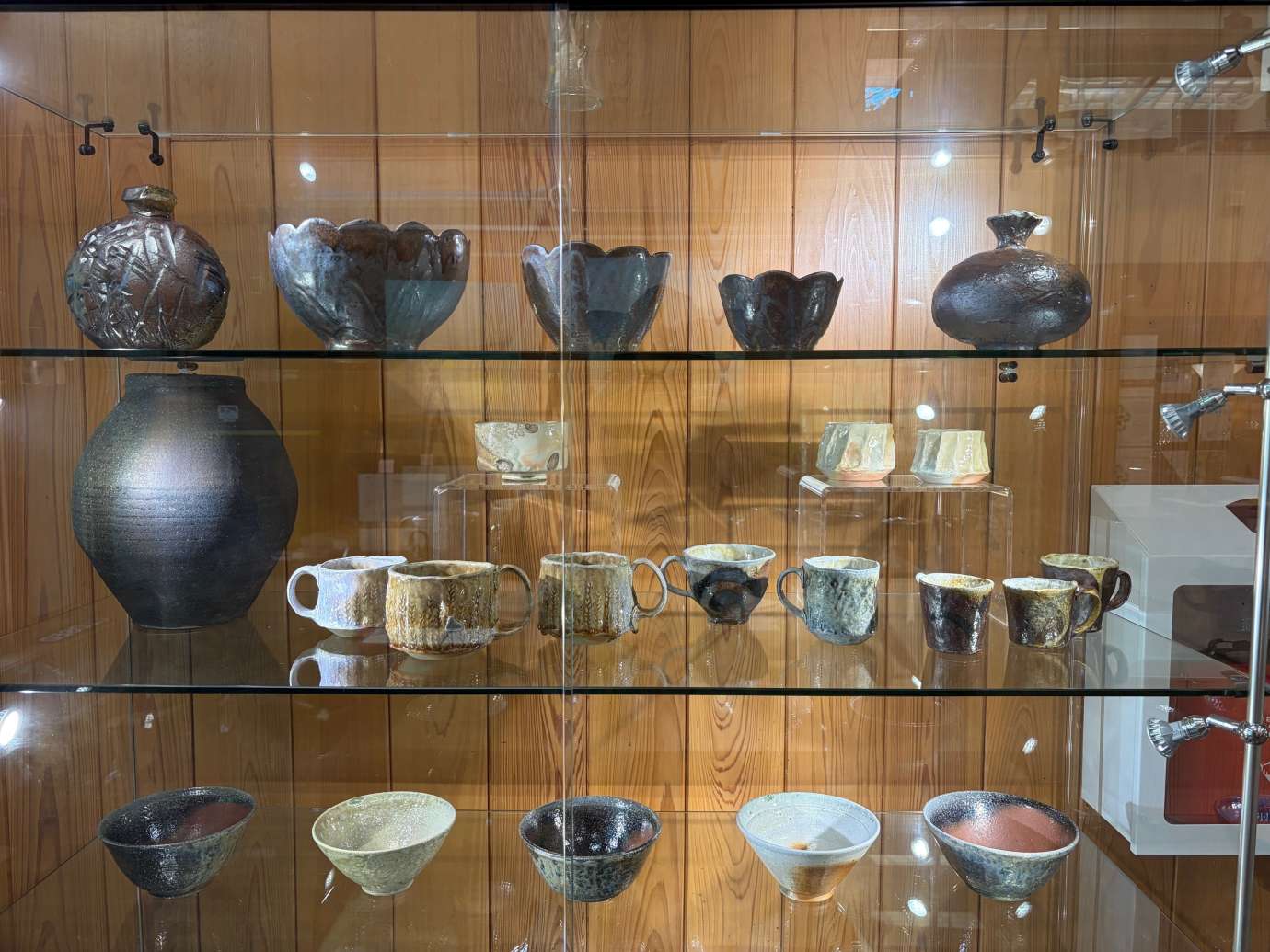 Pottery by Heather Lee McLelland in a Glass display case 