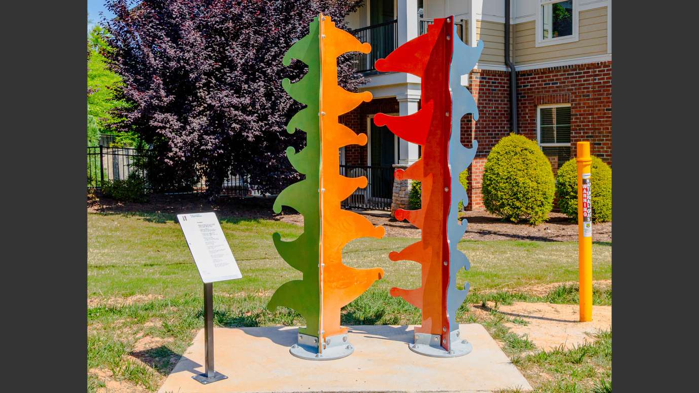 Brightly colored metal sculpture made of abstract shapes