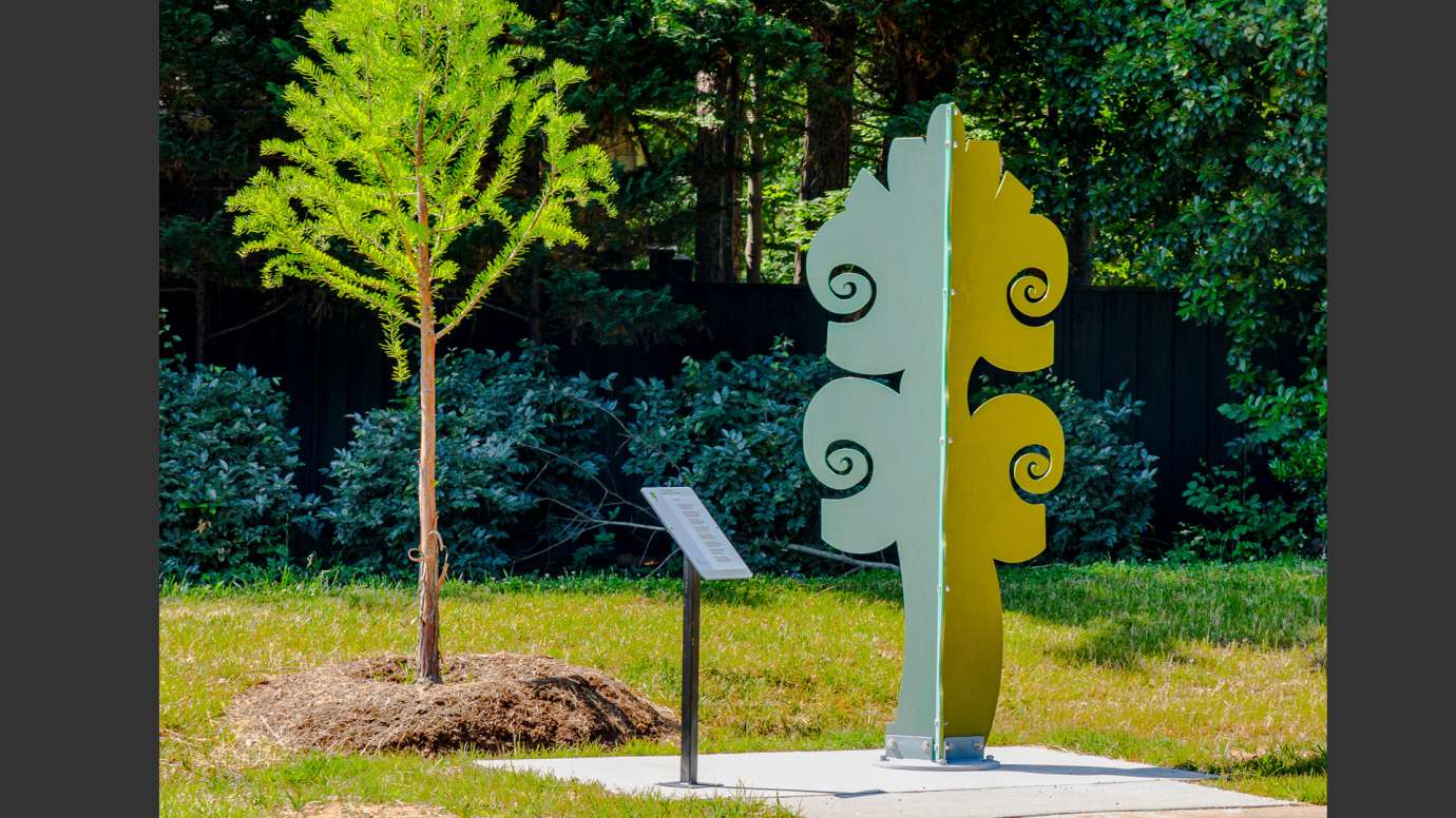 Brightly colored metal sculpture made of abstract shapes
