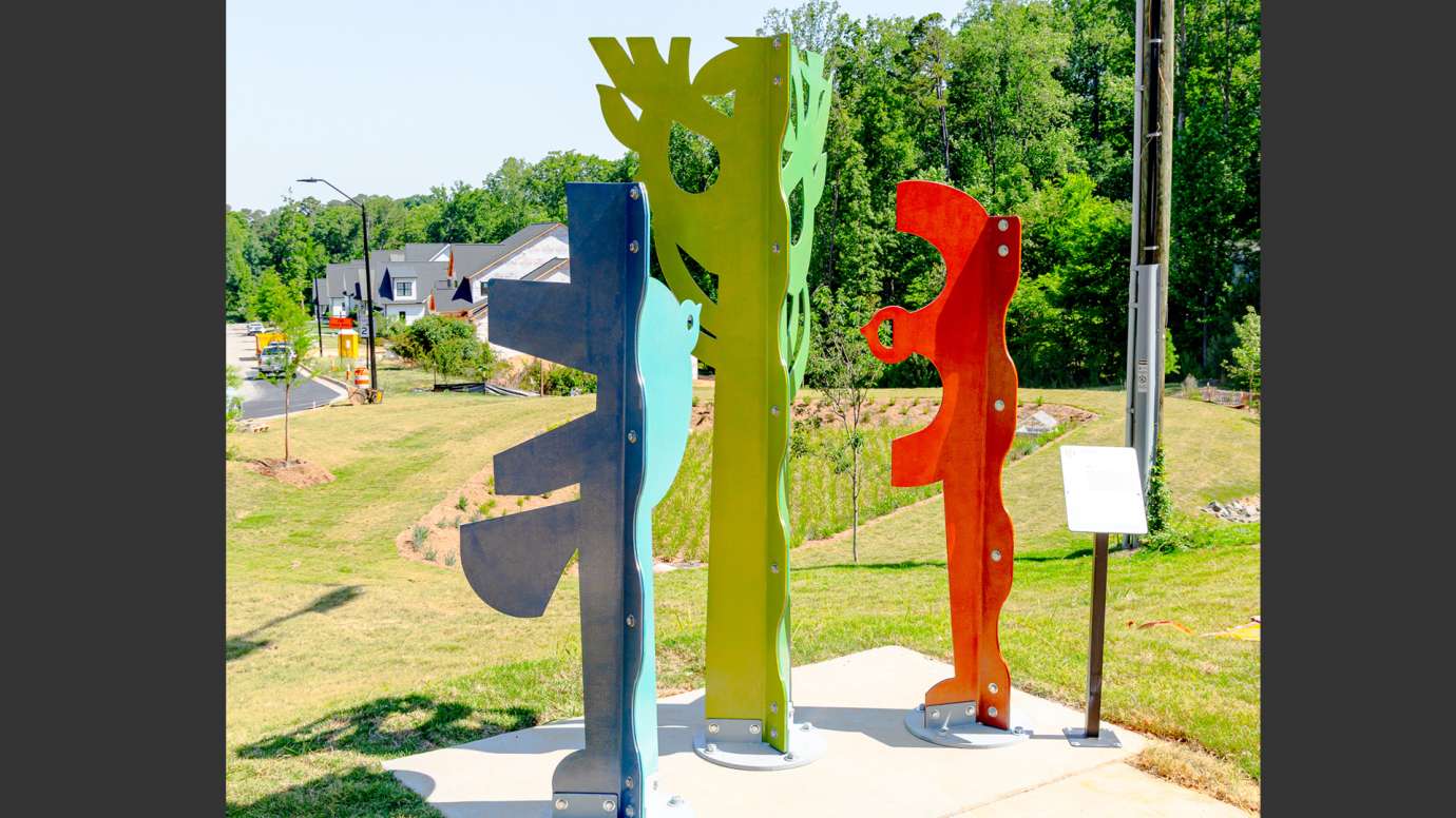Brightly colored metal sculpture made of abstract shapes