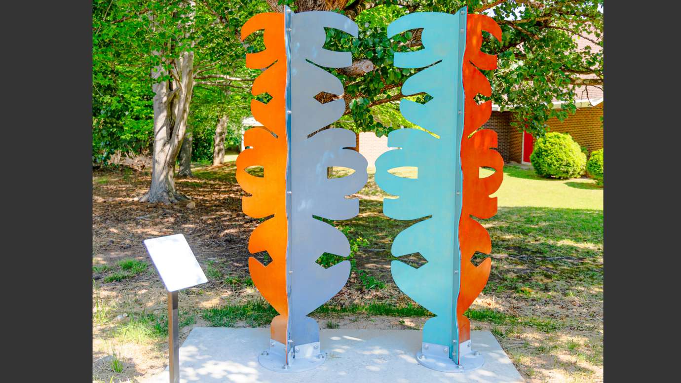 Brightly colored metal sculpture made of abstract shapes