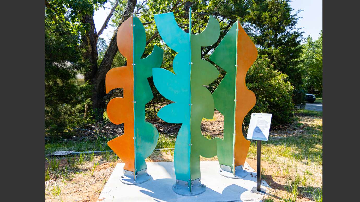 Brightly colored metal sculpture made of abstract shapes