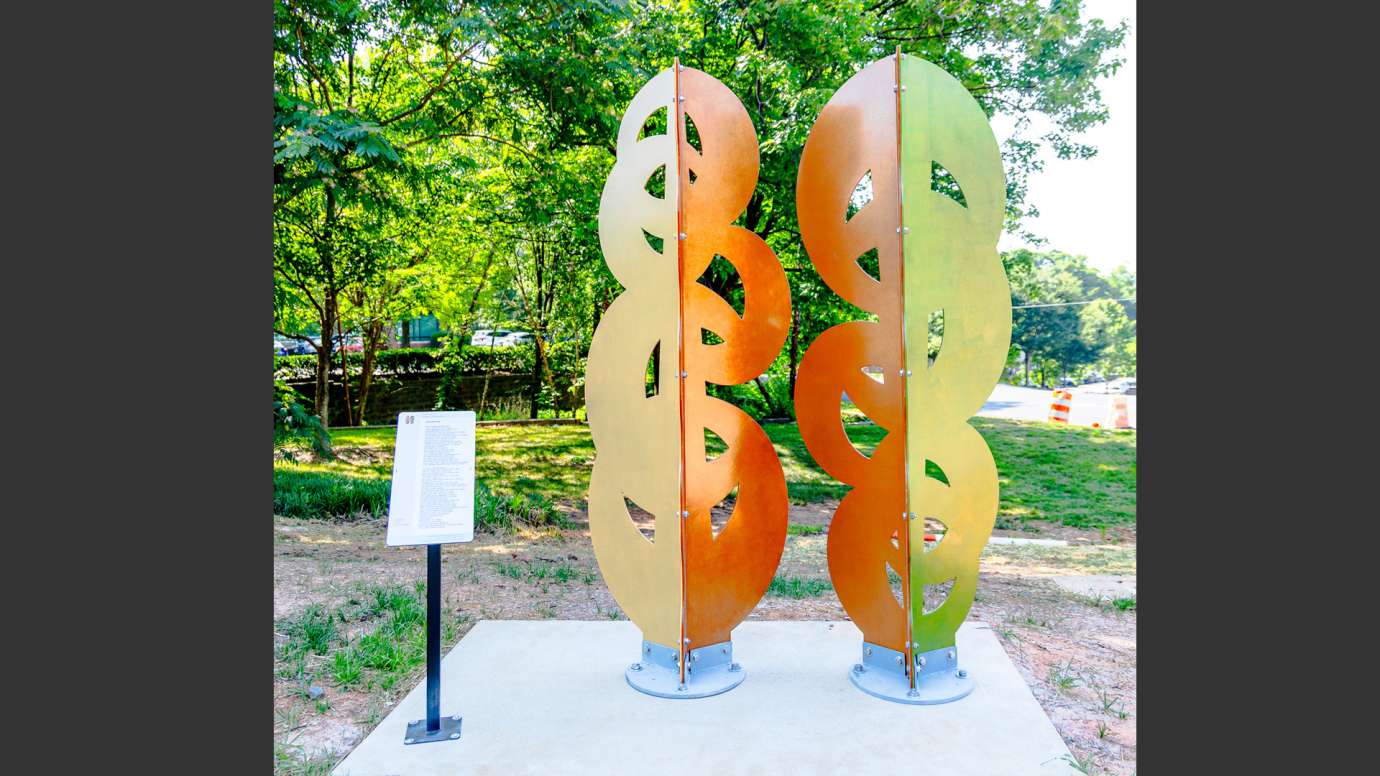 Brightly colored metal sculpture made of abstract shapes