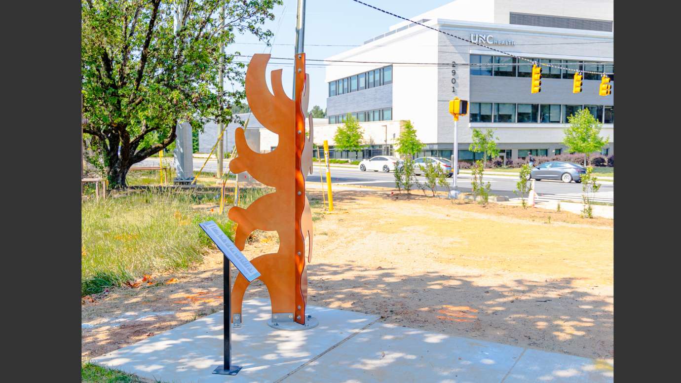 Brightly colored metal sculpture made of abstract shapes