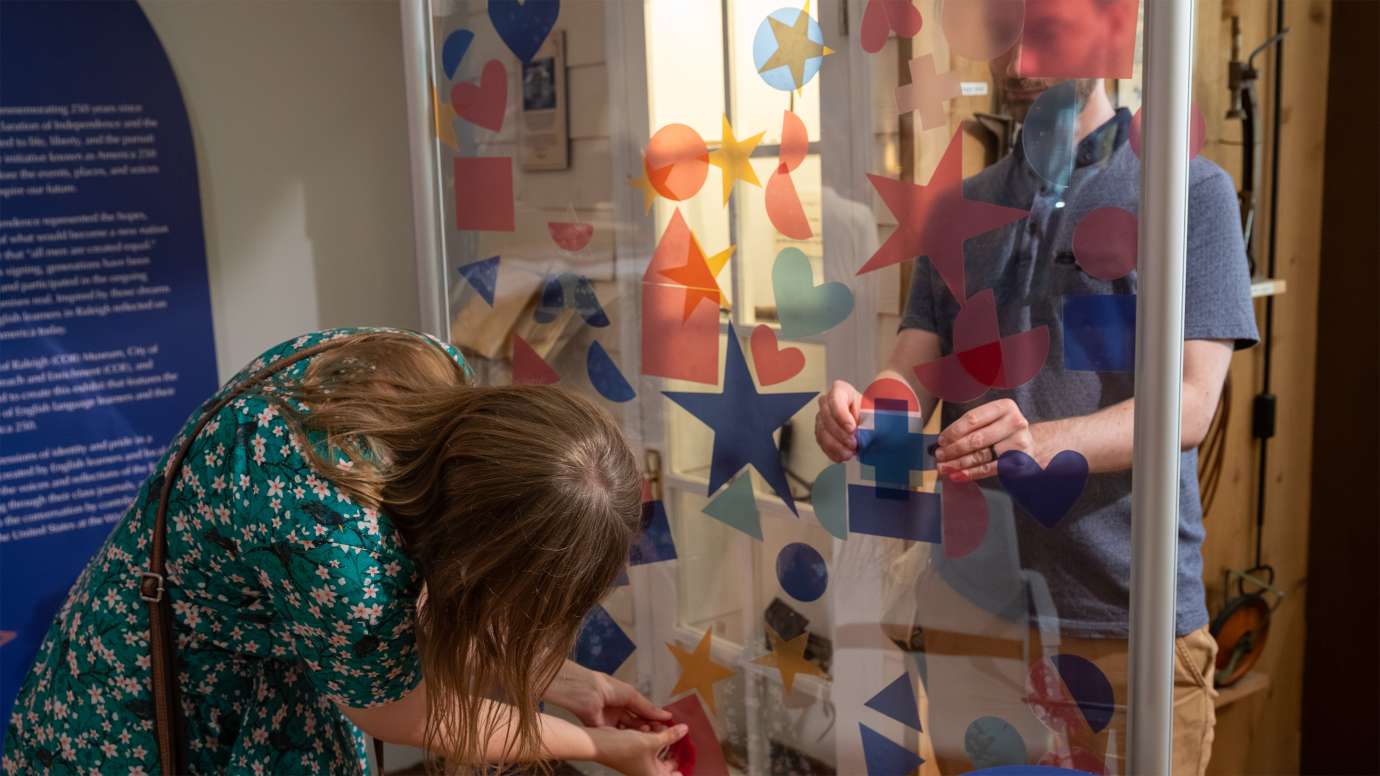 a couple of people participating with an interactive display