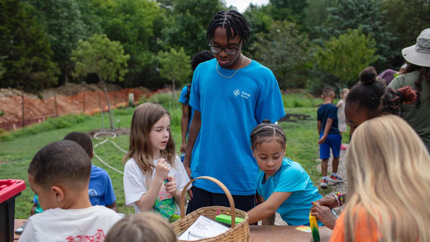 children enjoying the garden at marsh creek with their counselors