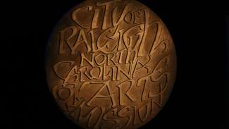 Medal of Arts award which reads City of Raleigh North Carolina Arts Commission